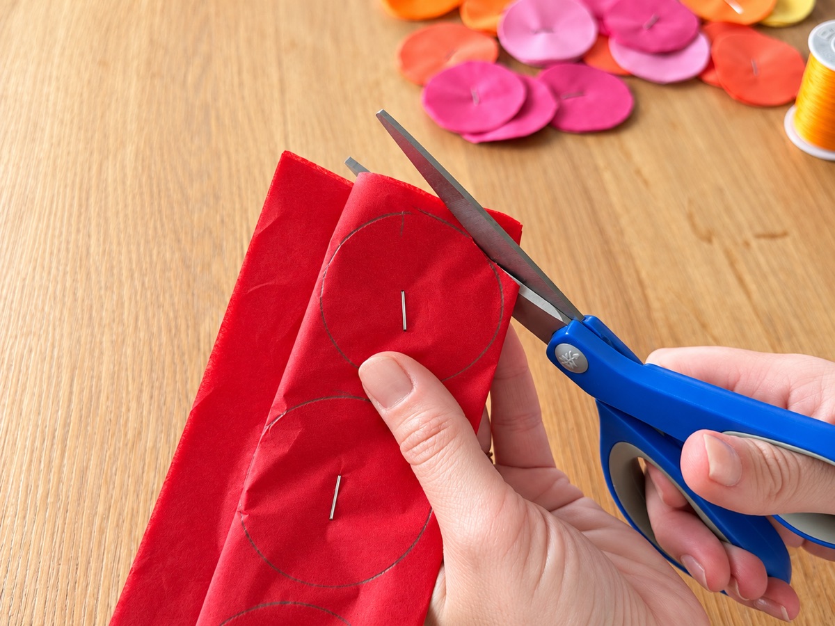 Cutting out a stapled circle with scissors.